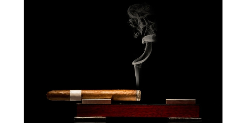 a lit cigar on wood