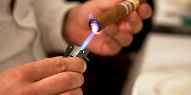 using a torch lighter to light a cigar