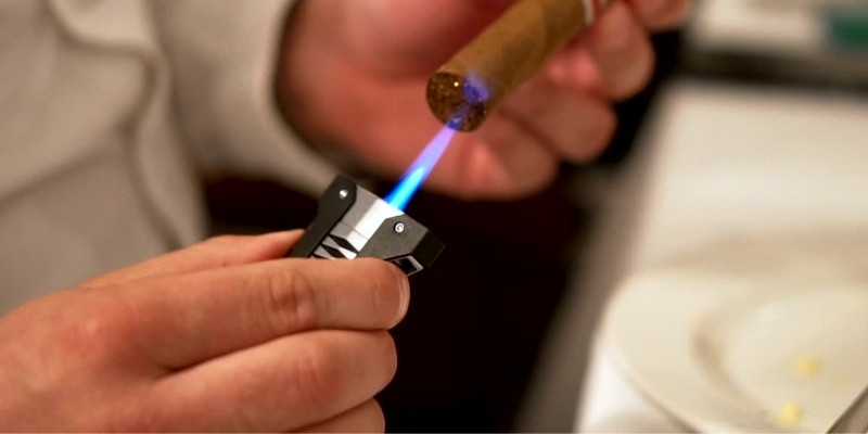 Lighting a cigar with a torch lighter
