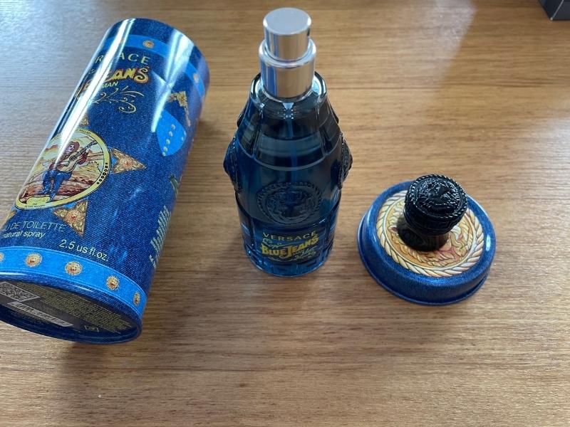 versace blue jeans opened bottle next to opened packaging canister